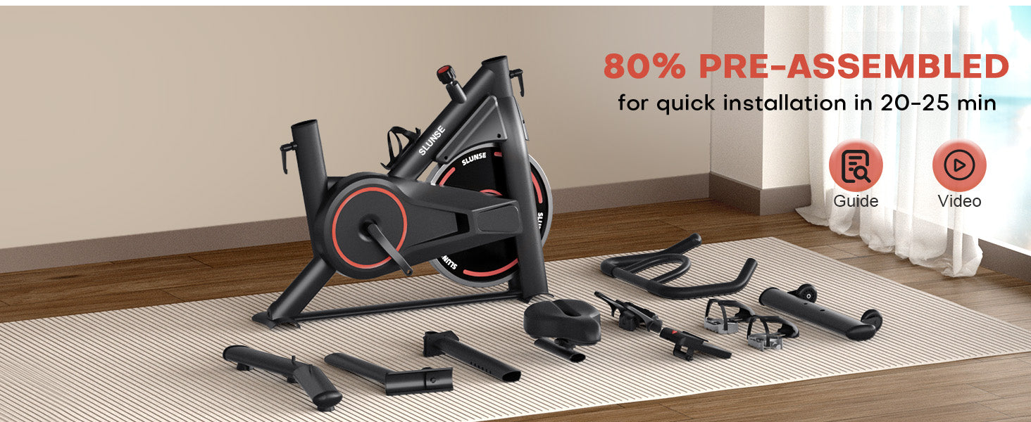 Home exercise bike with pre-assembled parts on a wooden floor.