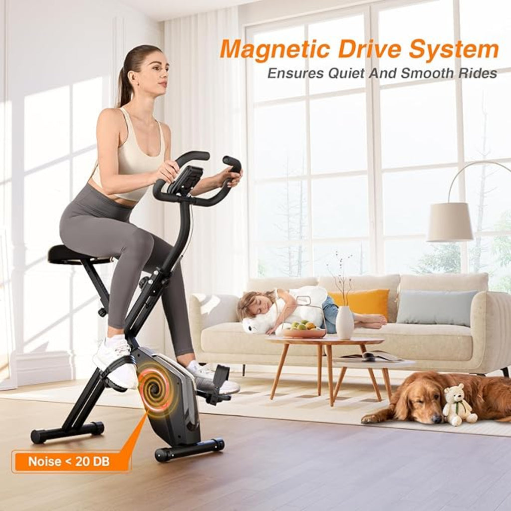 Woman exercising on a stationary bike in a living room with a dog and child in the background.