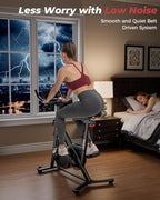 Woman exercising on a stationary bike in a bedroom with a cityscape view through the window.